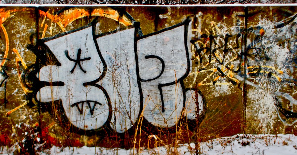Grandmaster Flash performing with graffiti-covered walls in the background