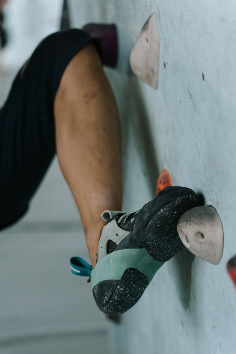 Person Stepping On A Climbing Hold