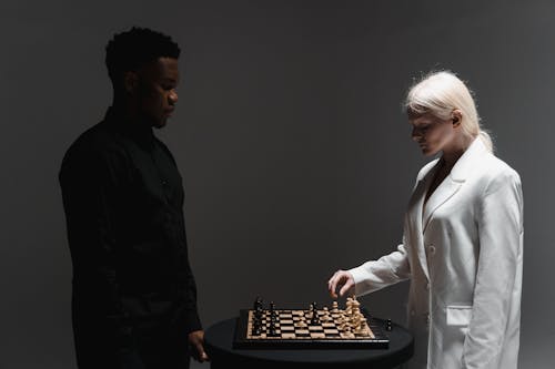 Free A Man and a Woman Playing Chess Stock Photo