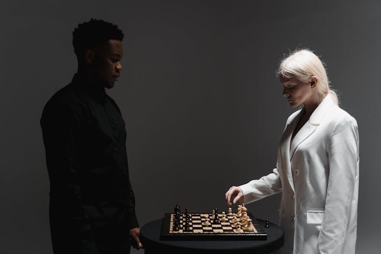 A Man And A Woman Playing Chess