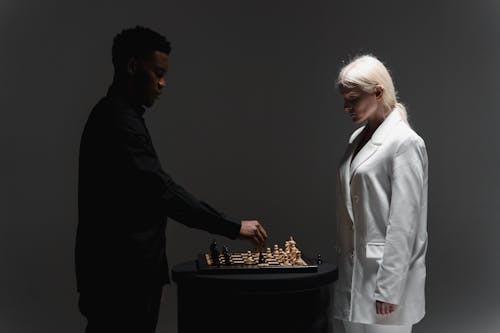 Free A Woman and a Man Playing Chess Stock Photo