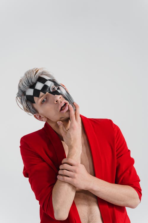 Photograph of a Man with Black and White Face Paint Posing