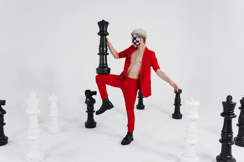 A Man Holding a Big Chess Piece