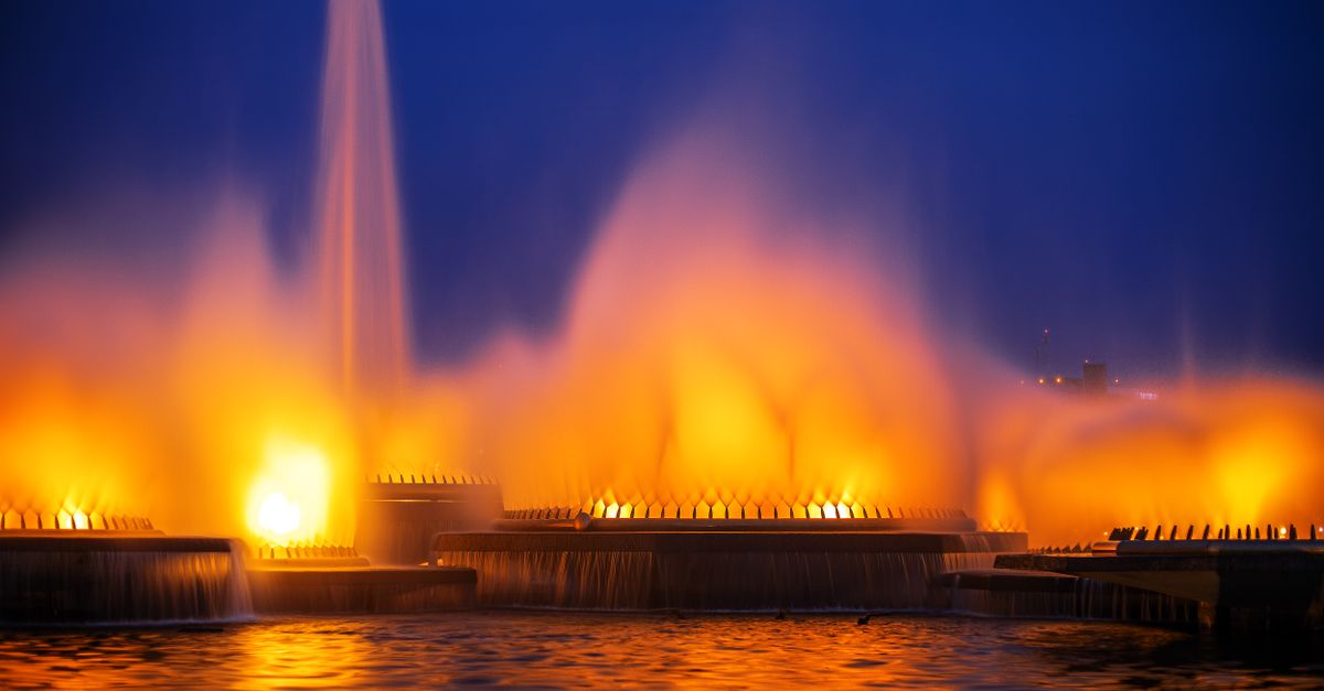 Vibrant illuminated fountains create a stunning night scene in Brasília, Brazil.