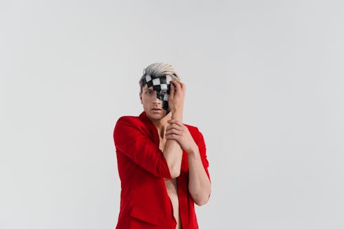 Man in Red Suit with Black and White Face Paint Posing