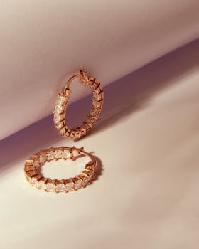 Close-up of exquisite diamond hoop earrings with rose gold setting, perfect for fashion and elegance.