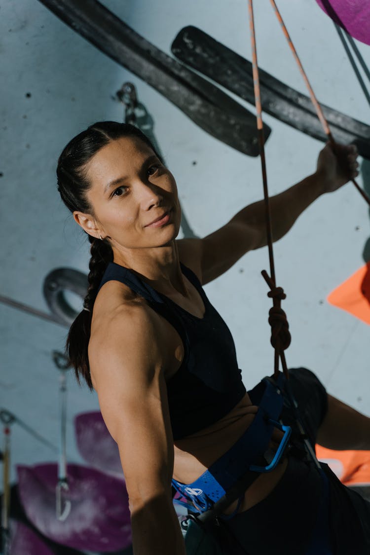 Woman Climbing A Wall