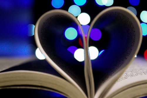 Free Photo of Bookpages Folded Into Heart Shape With Bokeh Light Background Stock Photo