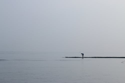 Free A Man Standing by the Sea Stock Photo