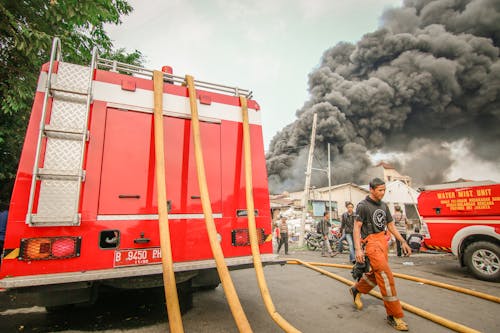 Photo of a Fire Truck in front of a Burning Building 