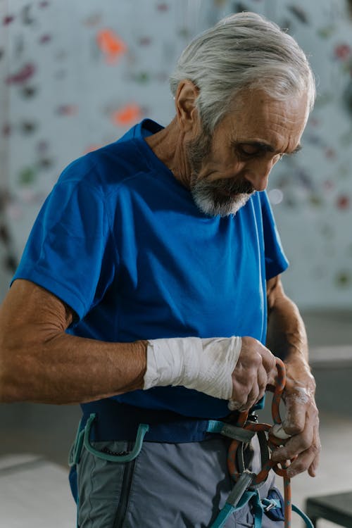 An Elderly Man Putting on Safety Harness