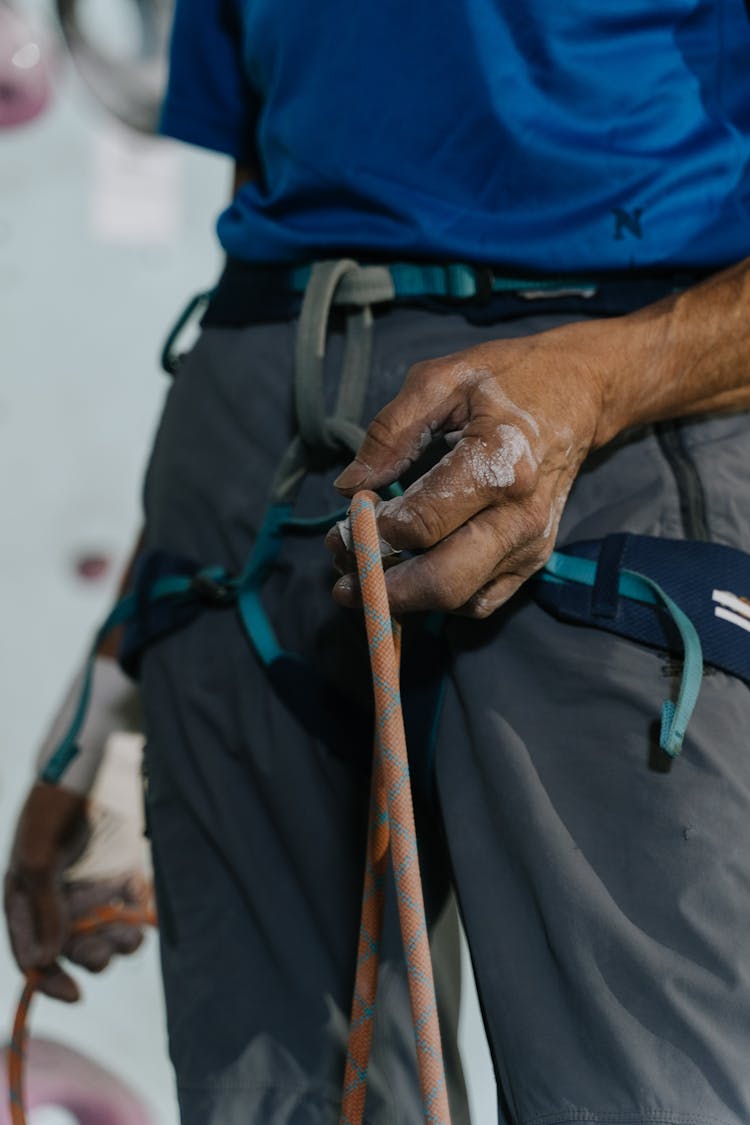 Person Wearing A Harness And Holding A Rope