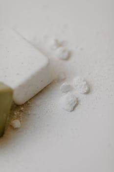 A minimalist close-up of organic soaps and powder for skincare.