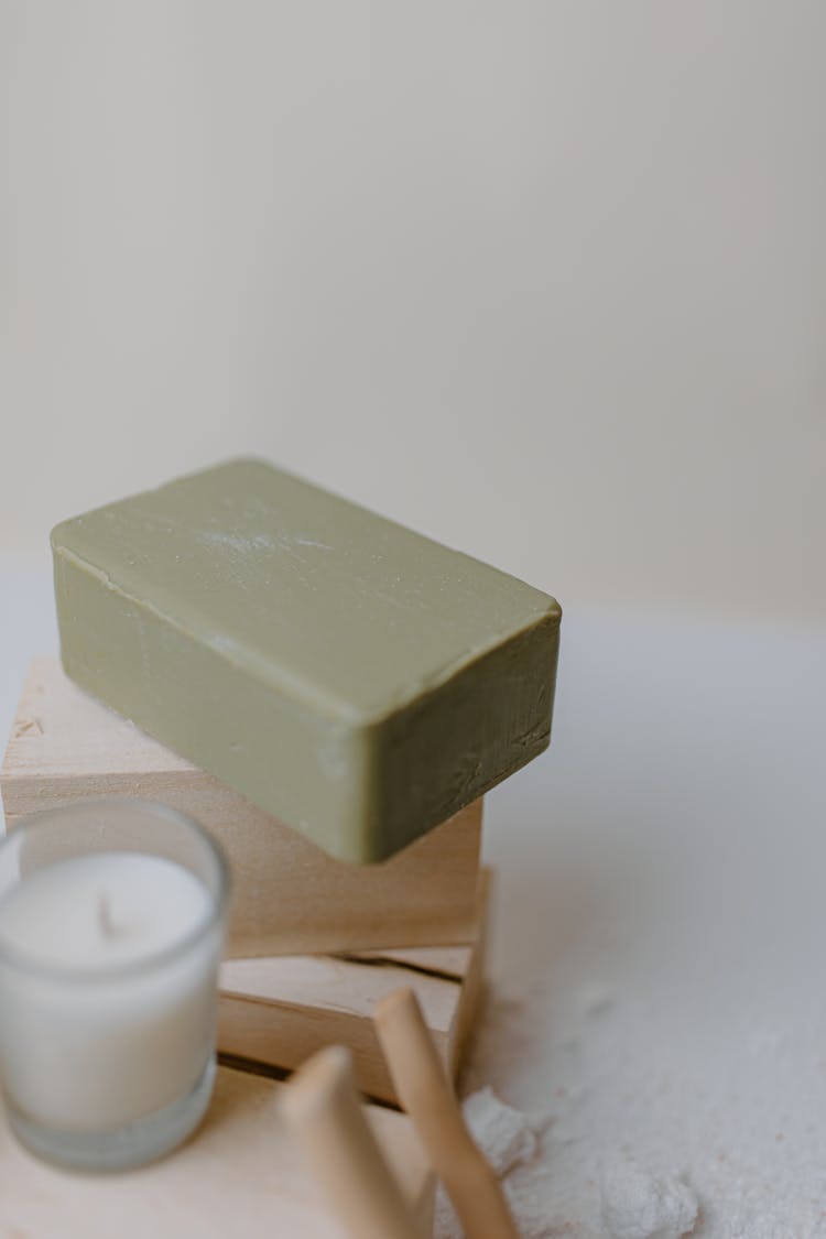 
A Green Soap On A Wooden Block