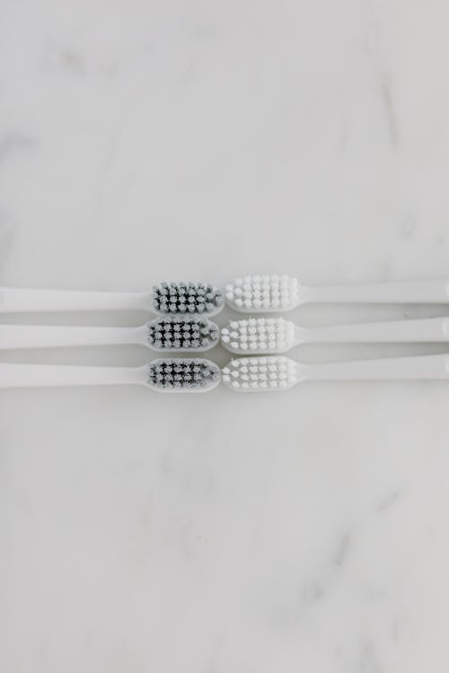 Free Top View of Toothbrushes on a Marble Surface Stock Photo