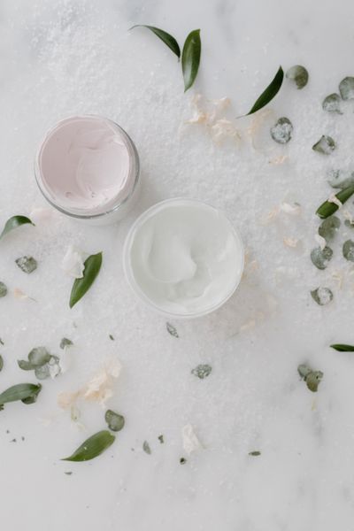 Two open cream jars on marble by Tara Winstead on Pexels