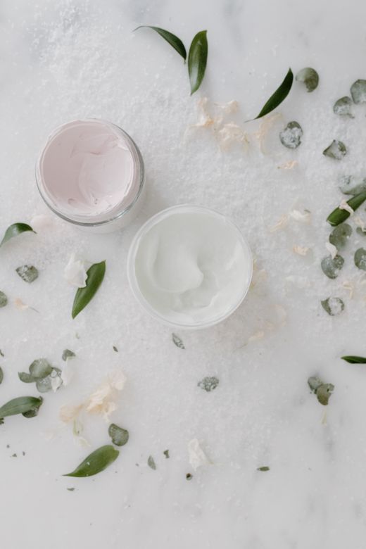 Cosmetic cream jars on a pale marble surface &mdash; photo by Tara Winstead on Pexels