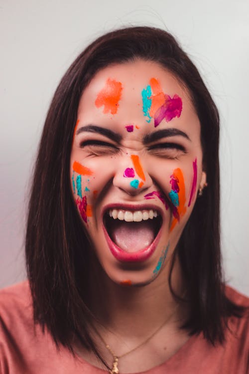 A Woman with Colorful Paint on Her Face 