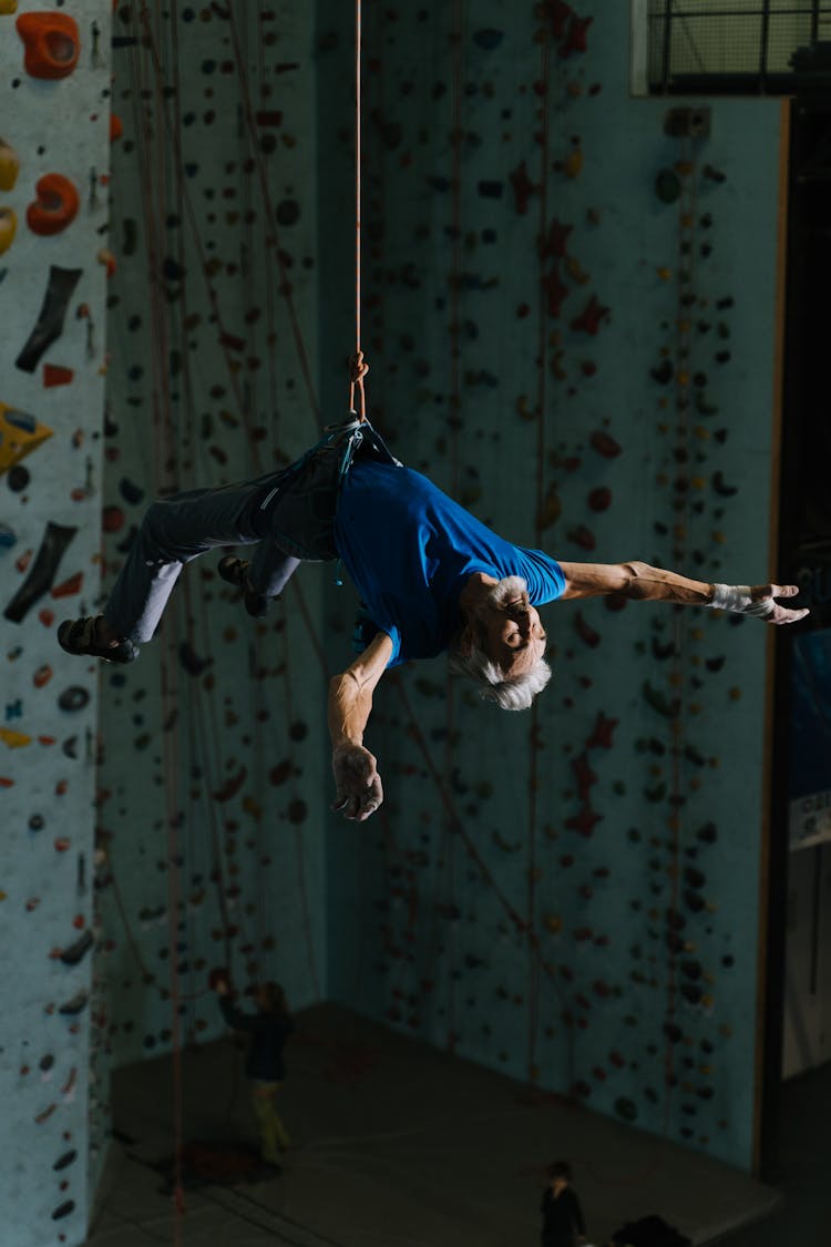 An Elderly Man Hanging From A Harness