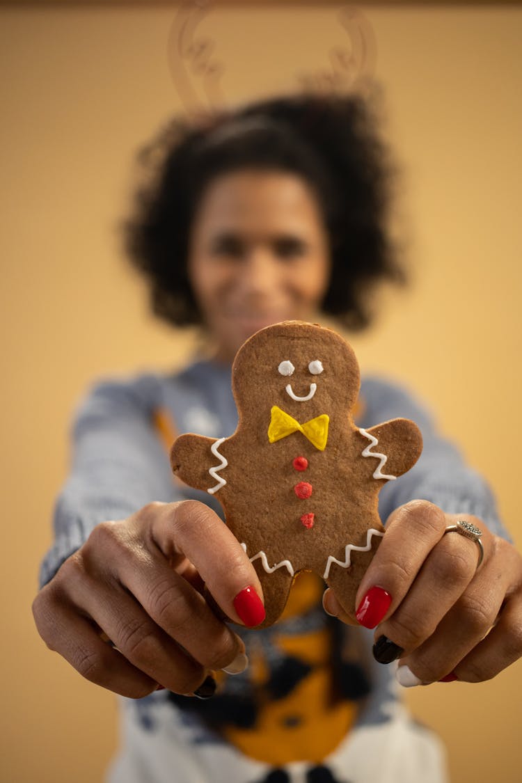 Woman Holding A Gingerbread Man Cookie