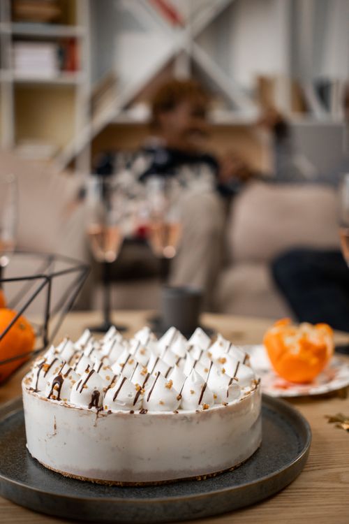Free A delectable meringue cake on a cozy table setting, perfect for special occasions. Stock Photo
