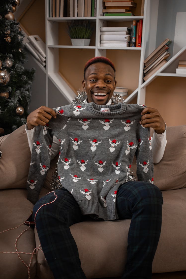 Happy Man Showing Winter Sweater Present