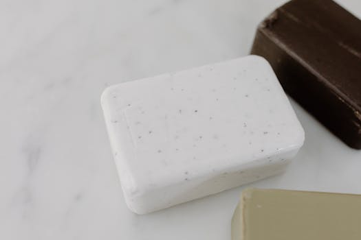 Close-up view of assorted soap bars on a marble surface, highlighting natural skincare routines.