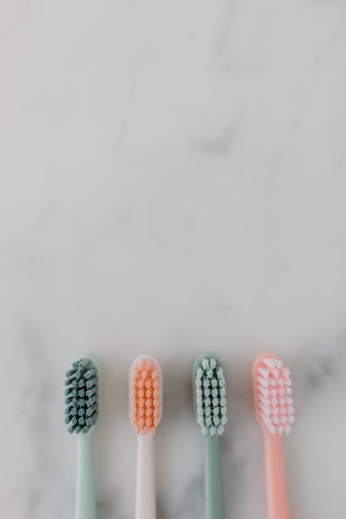 Overhead Shot of Toothbrushes on a Marble Surface