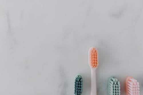 Top View of Toothbrushes on a Marble Surface