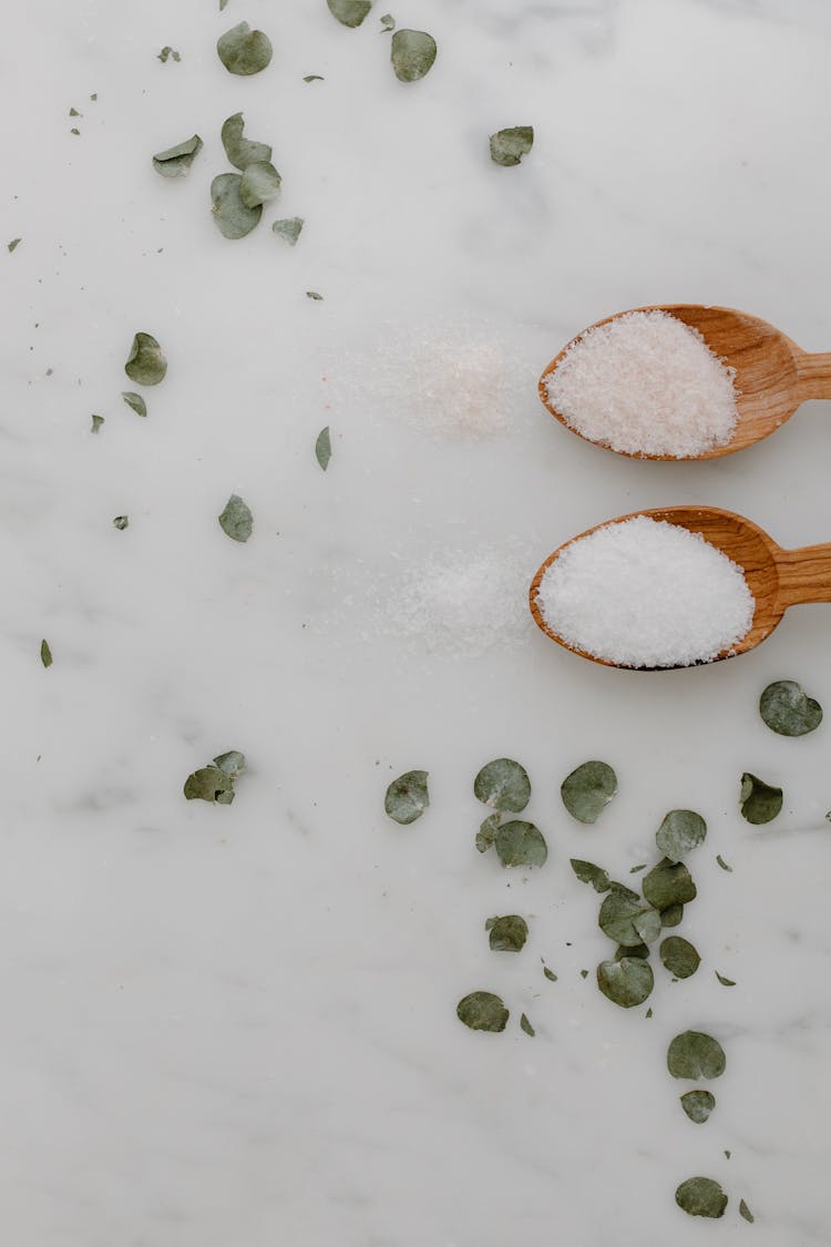 A Pair Of Wooden Spoons With Salt
