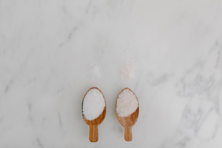 A Pair Of Wooden Spoon With Rock Salt