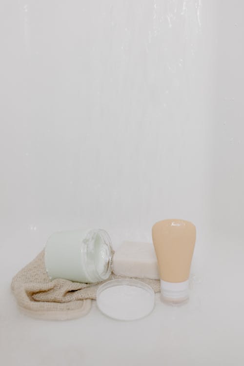 A Bar Soap and Creams on Towel