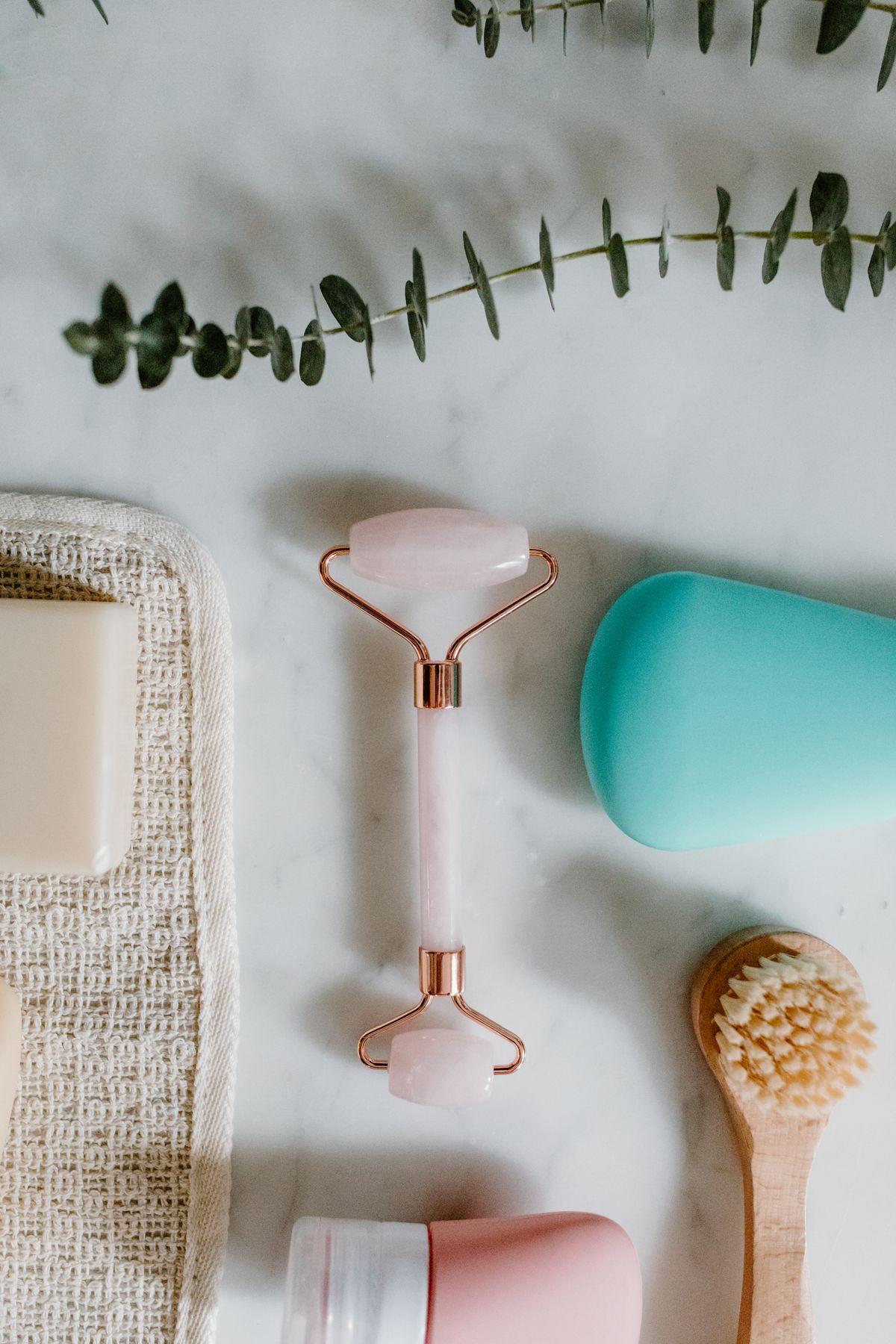Body care products including soap, facial roller, brush, and skincare essentials