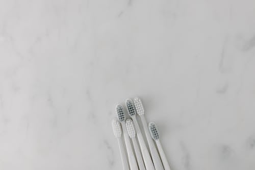Top View of Toothbrushes on a Marble Surface