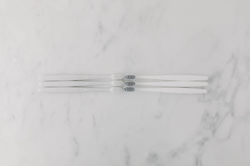 Top View of Toothbrushes on a Marble Surface