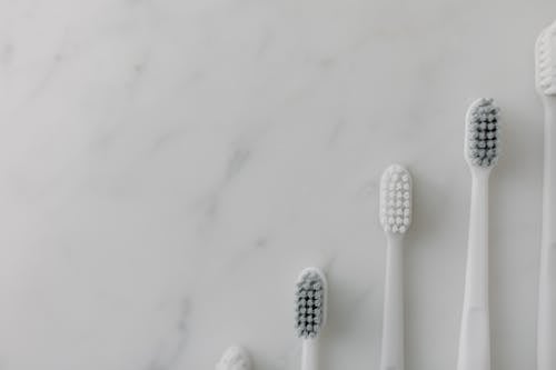 Top View of Toothbrushes on a Marble Surface