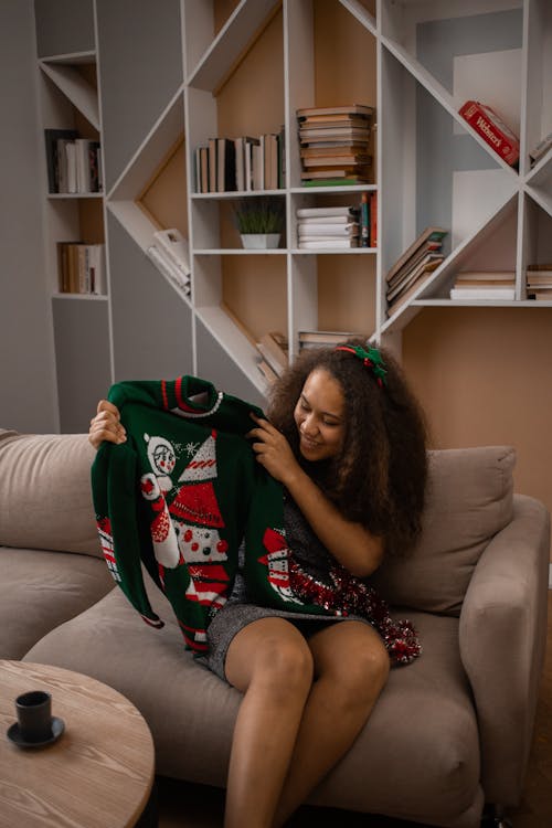 Smiling Woman Holding Christmas Sweater