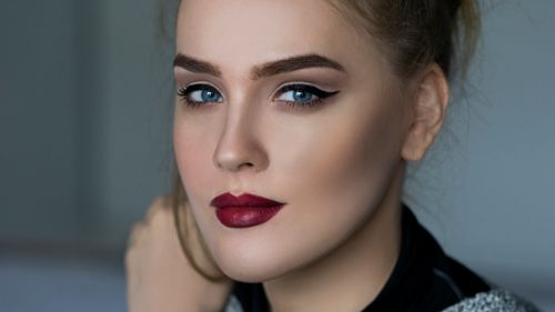 Free Close-up portrait of an elegant woman with striking makeup and blue eyes. Stock Photo