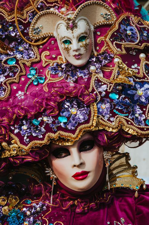 Free Close-up of an intricately designed Venetian carnival mask and costume, capturing mystery and elegance. Stock Photo