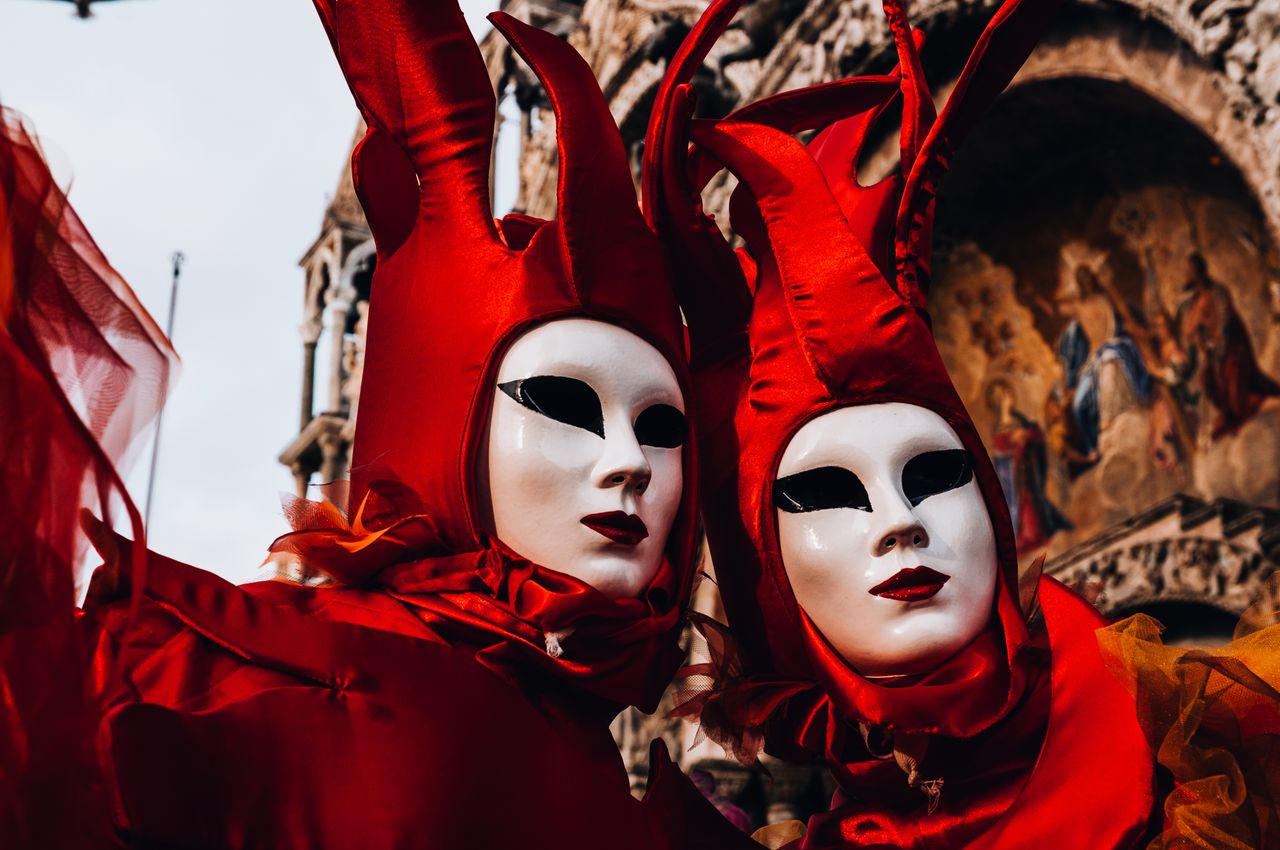 stunning venetian carnival masks and costumes in vibrant red during th