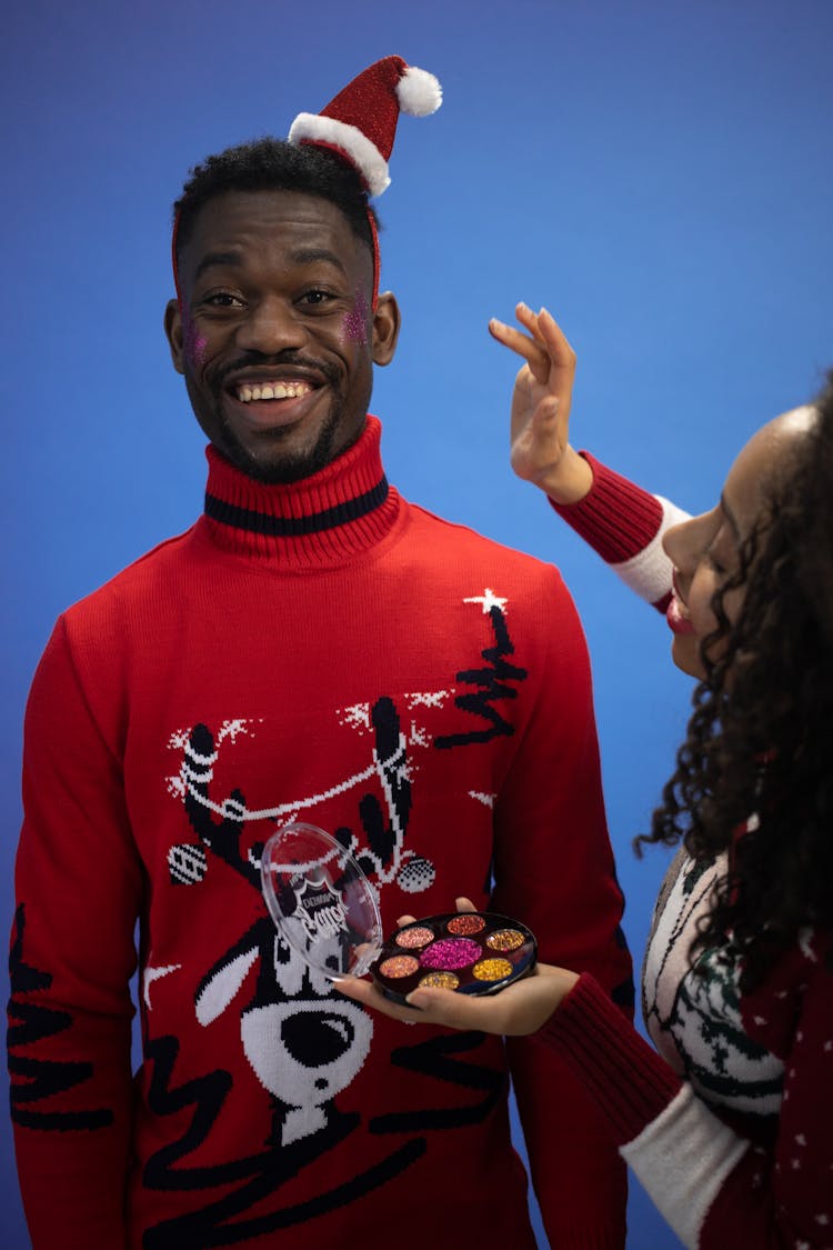 Man In Christmas Sweater And Funny Makeup