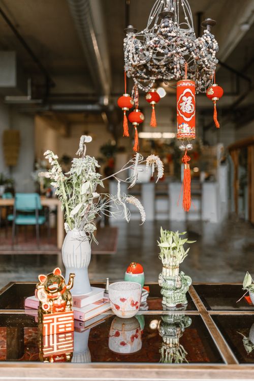 Free Elegant Chinese New Year decorations with vibrant red lanterns and cultural symbols on a reflective surface. Stock Photo
