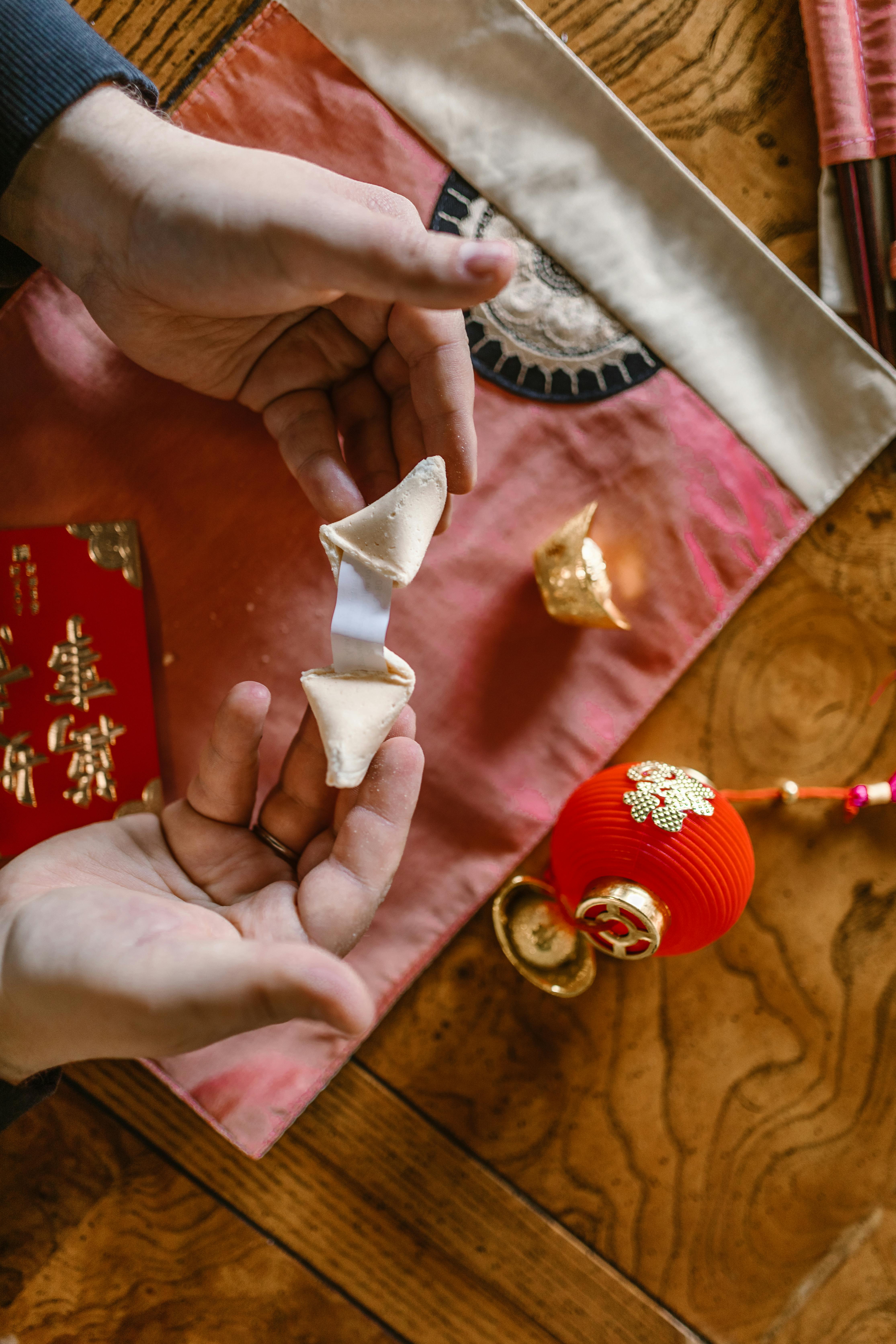 hands holding a fortune cookie