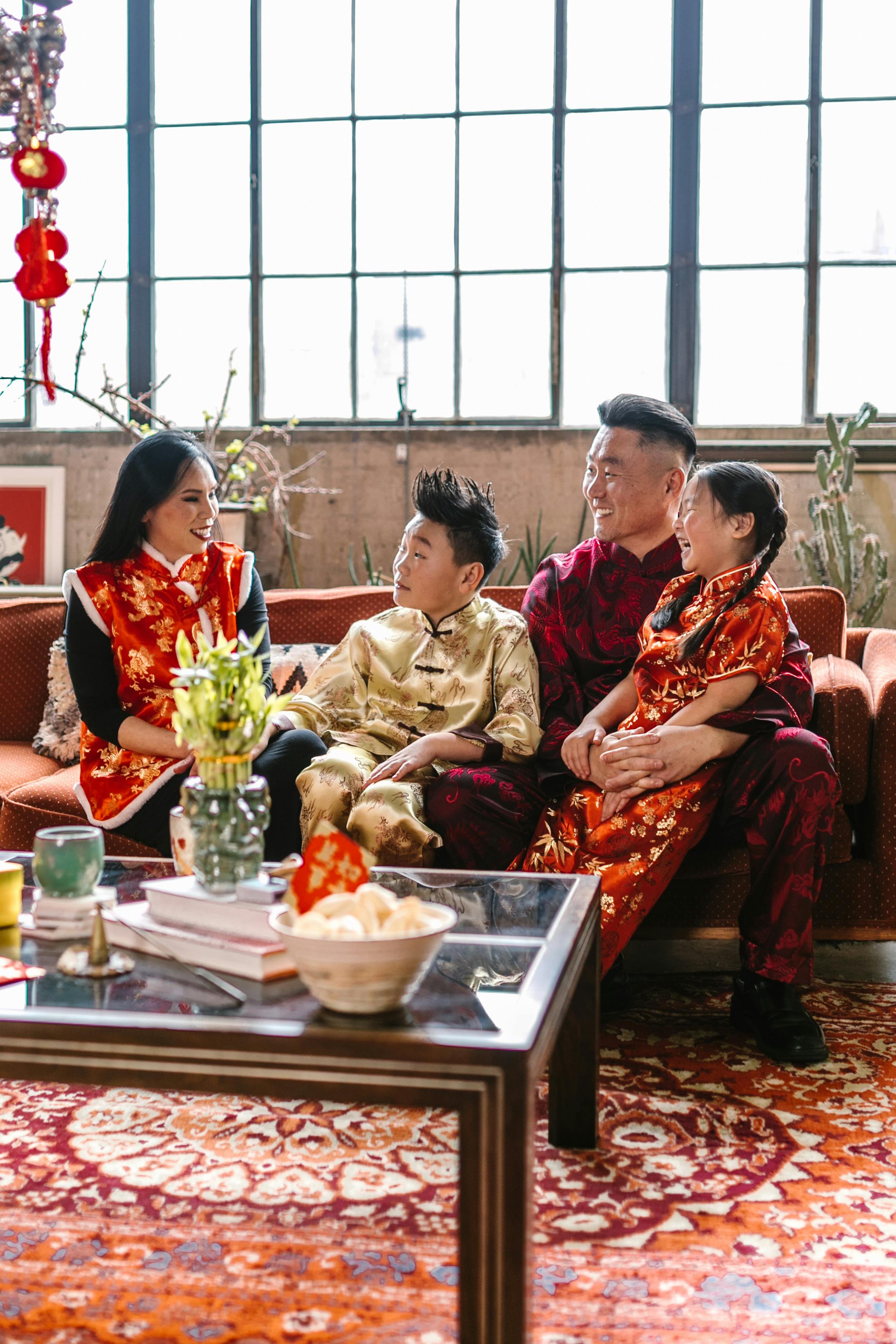 family wearing traditional clothes sitting in the living room