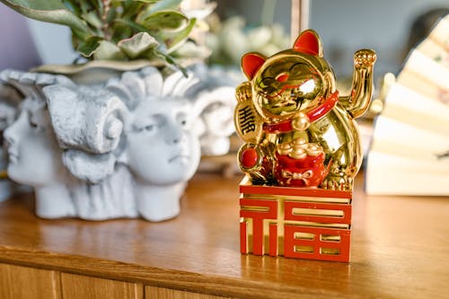 Golden Lucky Cat over a Wooden Table