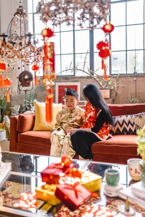 Free A joyful moment between a mother and son celebrating Chinese New Year indoors with vibrant decorations. Stock Photo