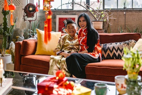 A Mother and Son in Traditional Wear Sitting on Couch