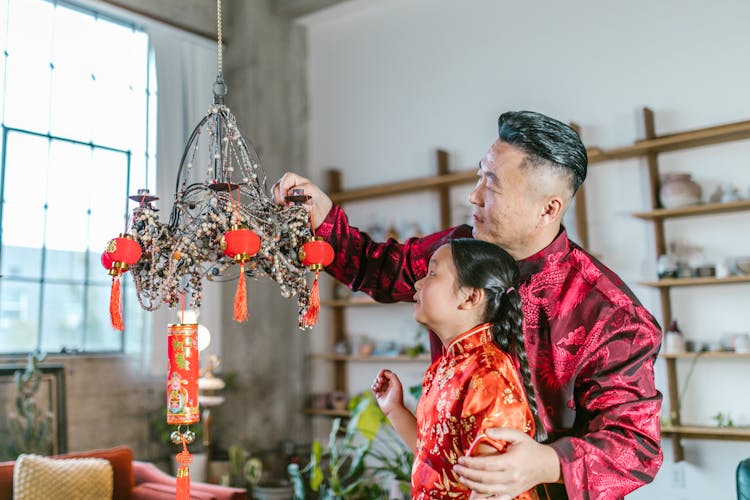 Shallow Focus Of A Father And Daughter Looking At Chinese Lantern