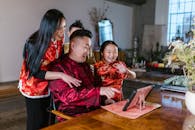 A Family in Traditional Clothing Having a Video Call