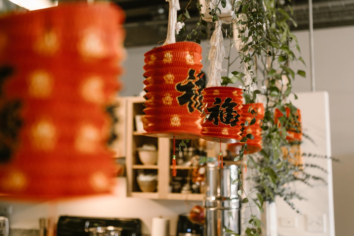 Decorative red lanterns with Chinese characters hanging in an indoor setting, adding festive charm to the space